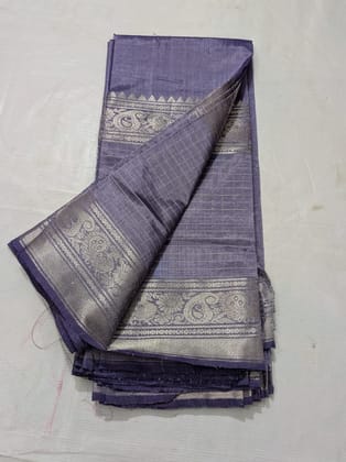 A beautiful, traditional Indian silk saree in a deep blue color with silver zari work. A beautiful, traditional Indian silk saree in a deep blue color with silver zari work.