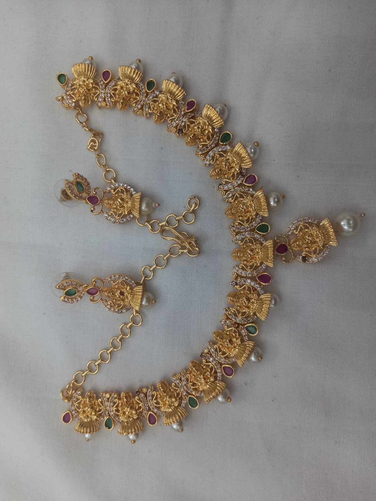 "Stunning Lakshmi Temple Jewelry Set in Gold with Pearls and Green Stones"