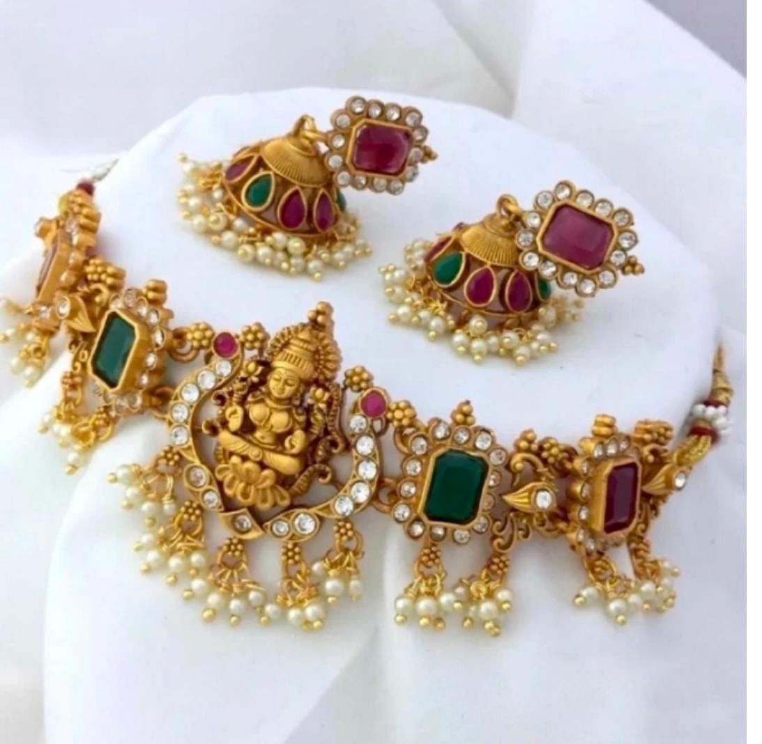"Stunning antique gold plated temple necklace set with Goddess Lakshmi pendant, green and pink stones, and pearl drops."
