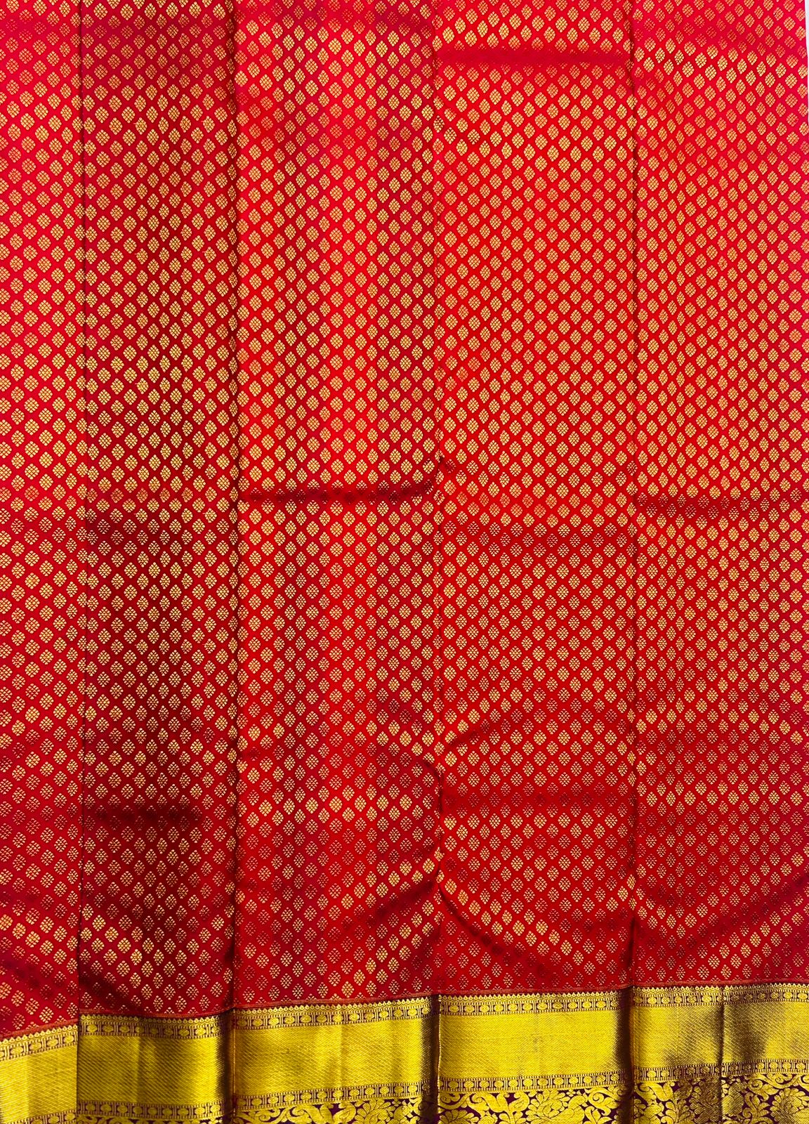 Red and gold silk brocade fabric with traditional Indian design
