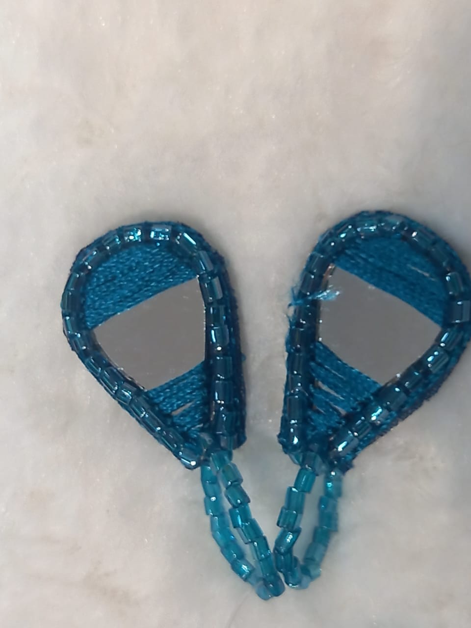 A pair of blue embroidered saree & pallu hangings with mirrors and thread