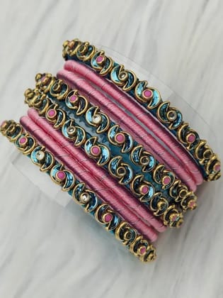 Set of 8 bangles, pink and blue, with gold accents and pink stones.