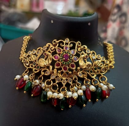 Stunning antique gold choker necklace with intricate filigree work and colorful gemstones.