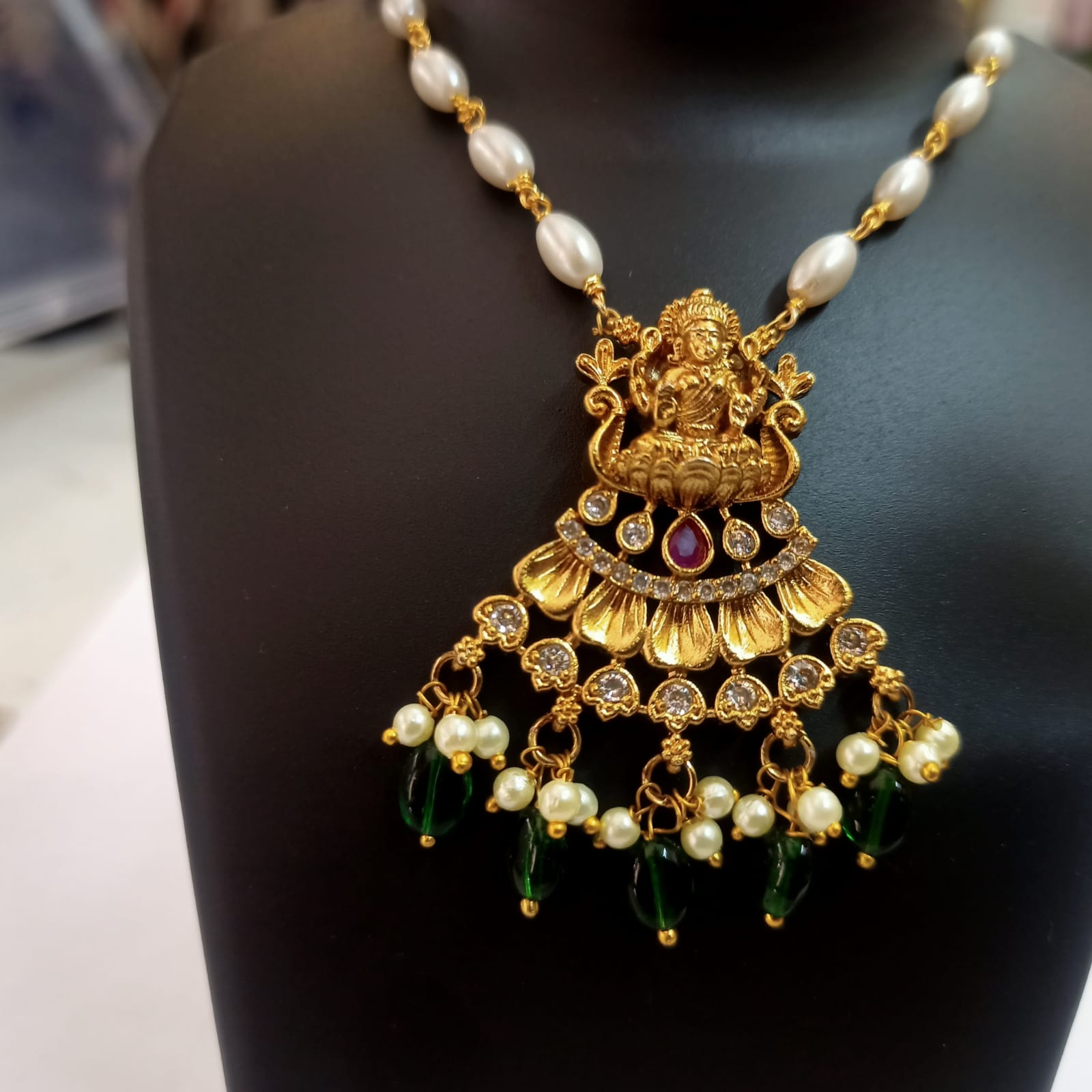 Pearl and gold plated Goddess Lakshmi pendant necklace with green beads