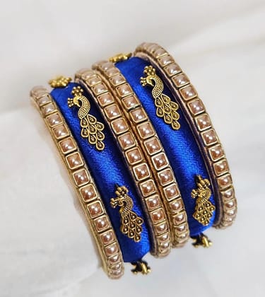 Set of 6 Blue Silk Thread Bangles with Golden Peacock Design and Pearl Beads Set of 6 Blue Silk Thread Bangles with Golden Peacock Design and Pearl Beads