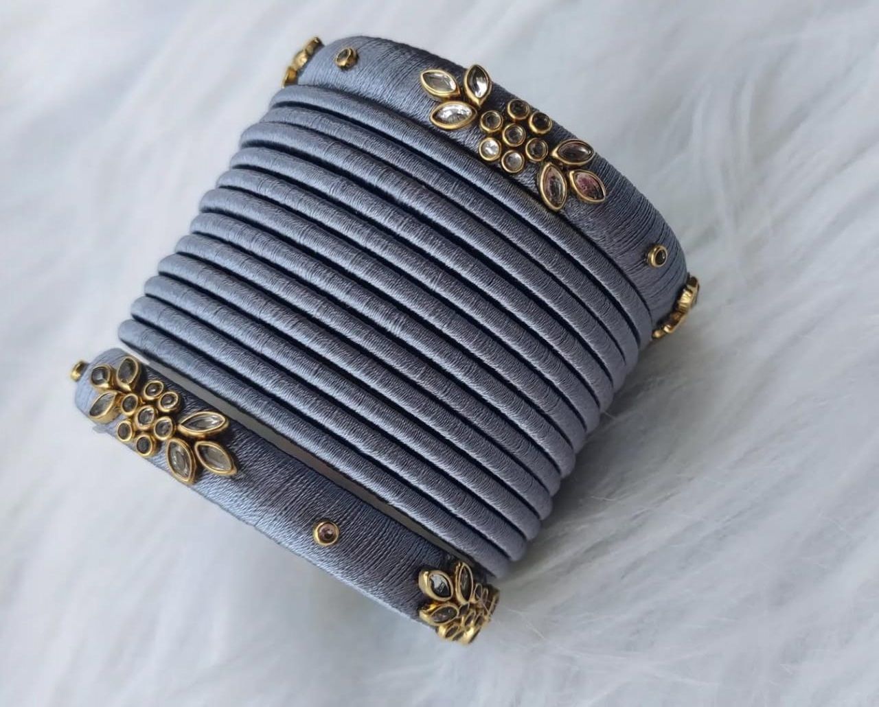 oxidised finish grey silk thread bangles with golden floral design