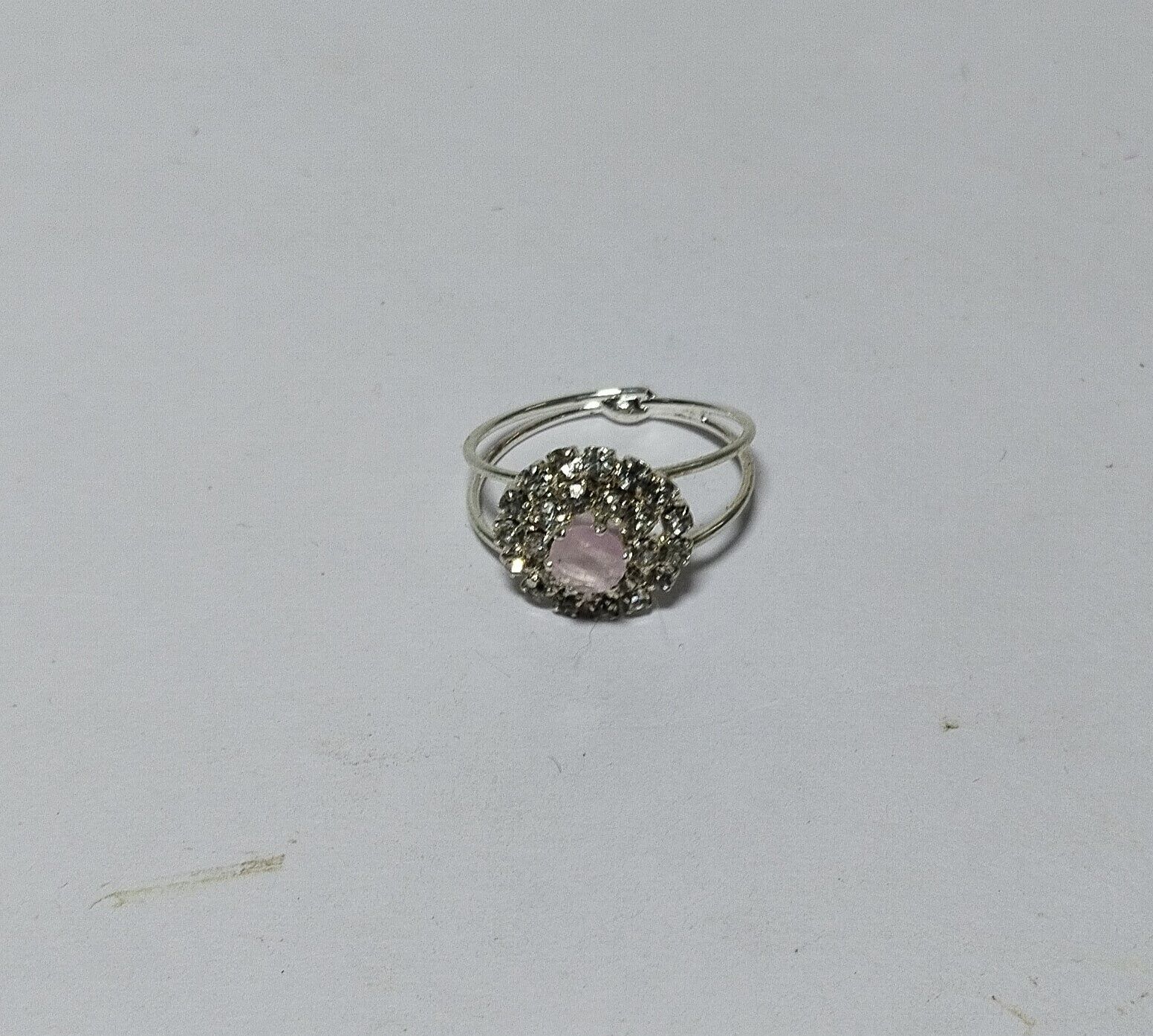 "Elegant Silver-Plated Ring with Pink Center Stone and Rhinestone Accents"
