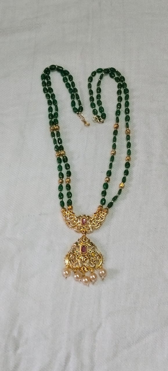 "Stunning Gold Pendant Necklace with Green Beads and Pearl Accents"