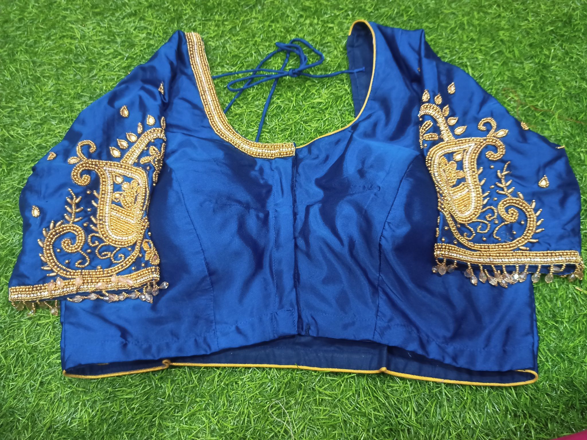 Blue blouse with intricate golden embroidery and mirror work