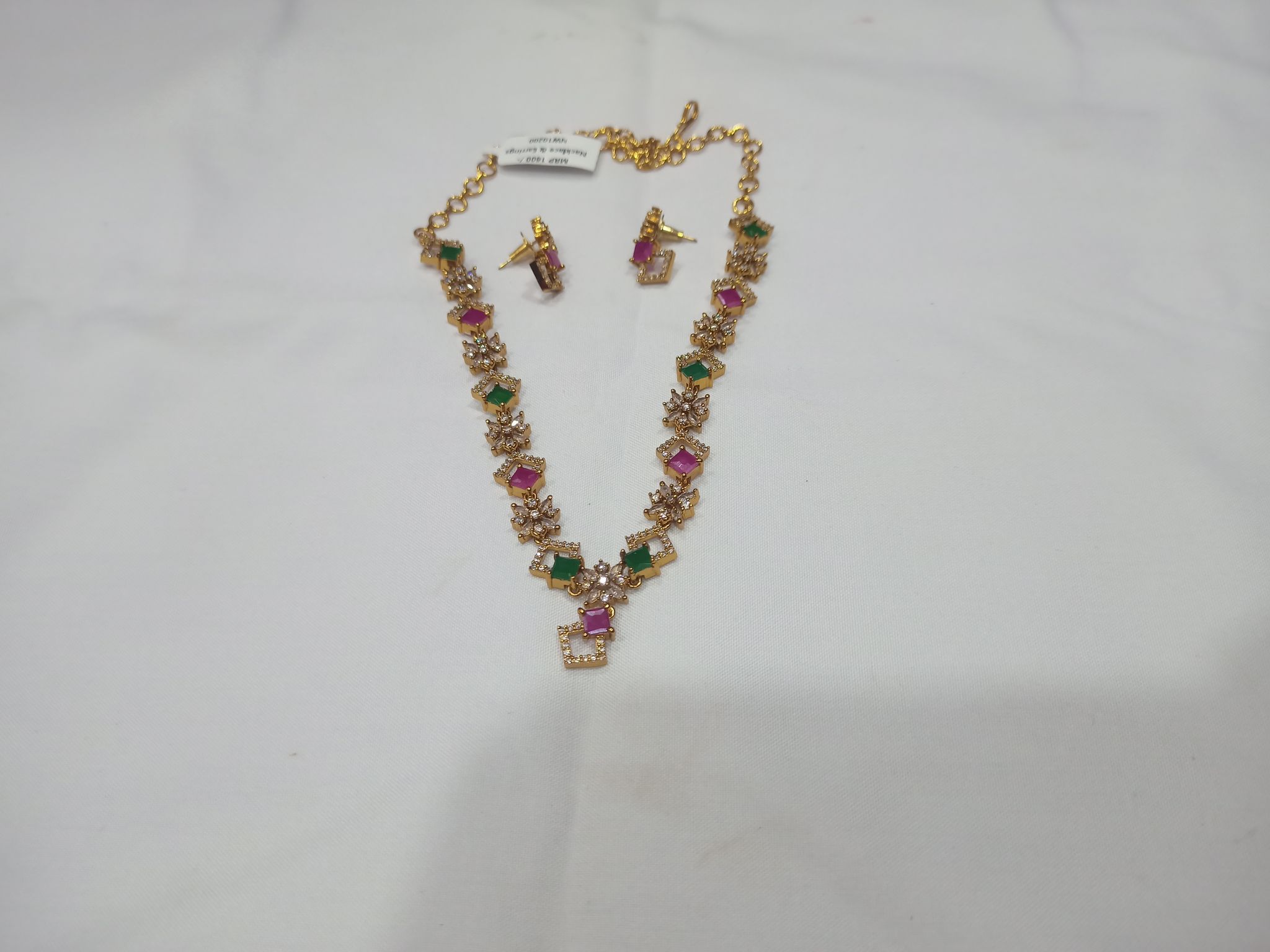 Gold-plated square-shaped American diamond necklace set with green and pink stones