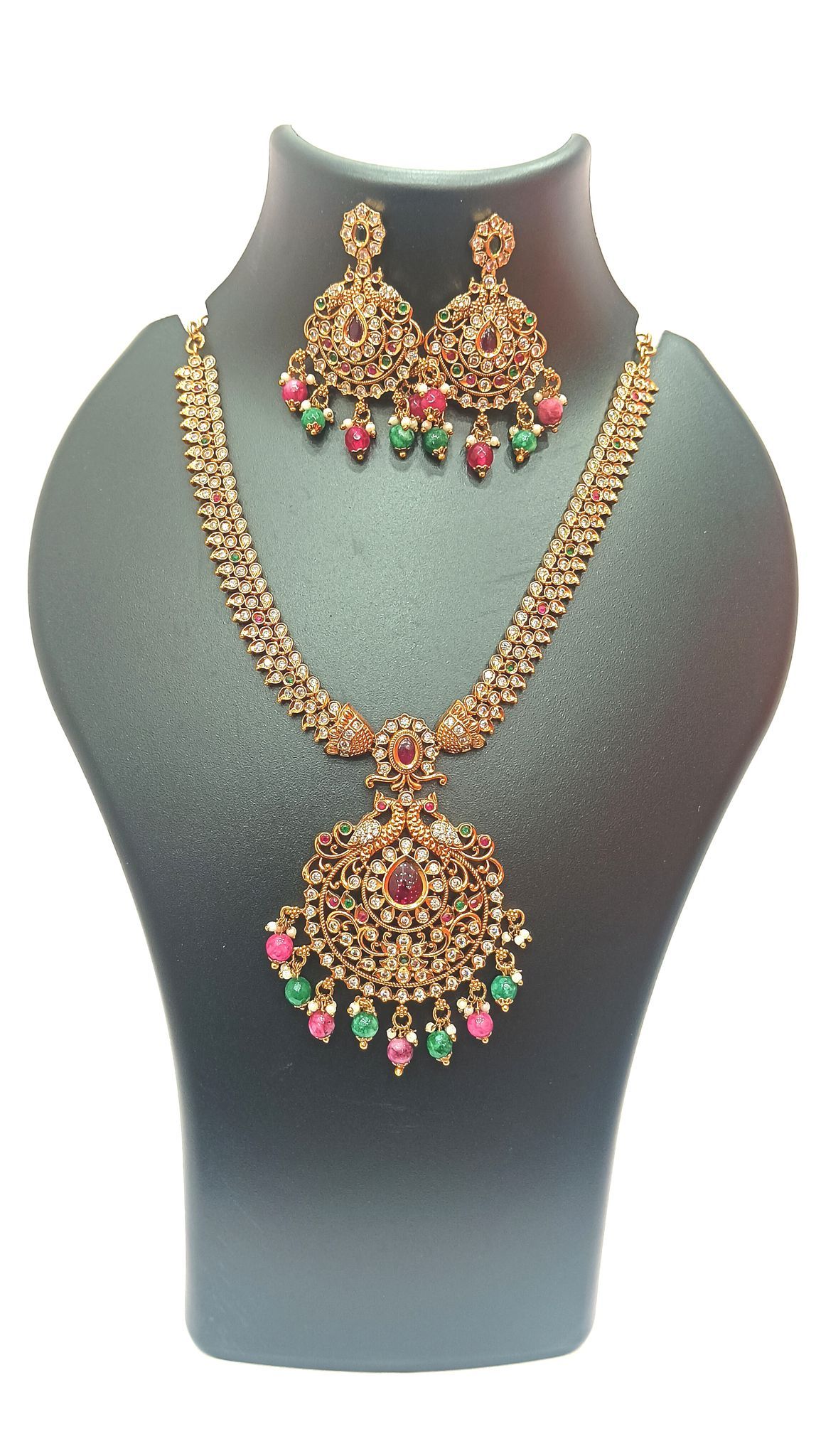 Gold-plated traditional Indian necklace set with intricate detailing and colorful stones