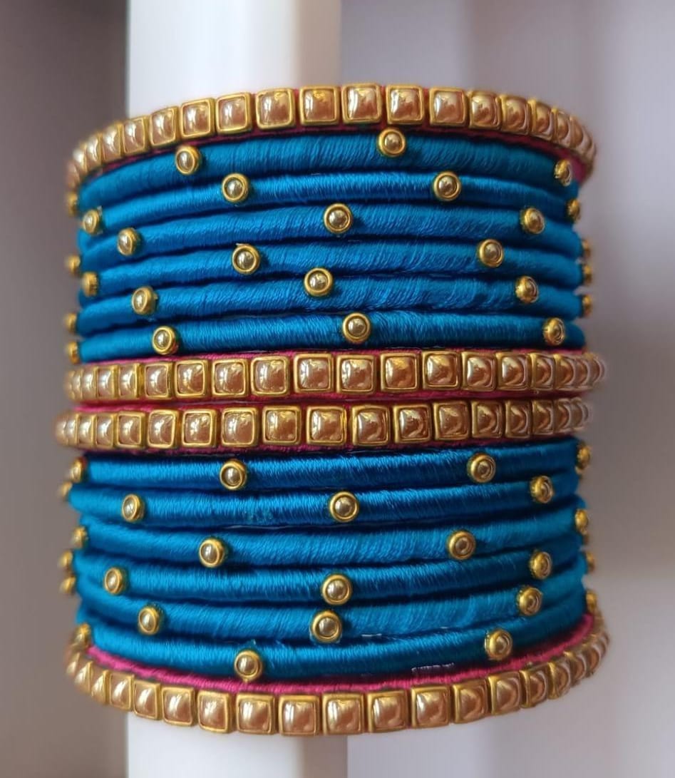 Set of 16 Blue Silk Thread Bangles with Golden Beads and Pink Stones