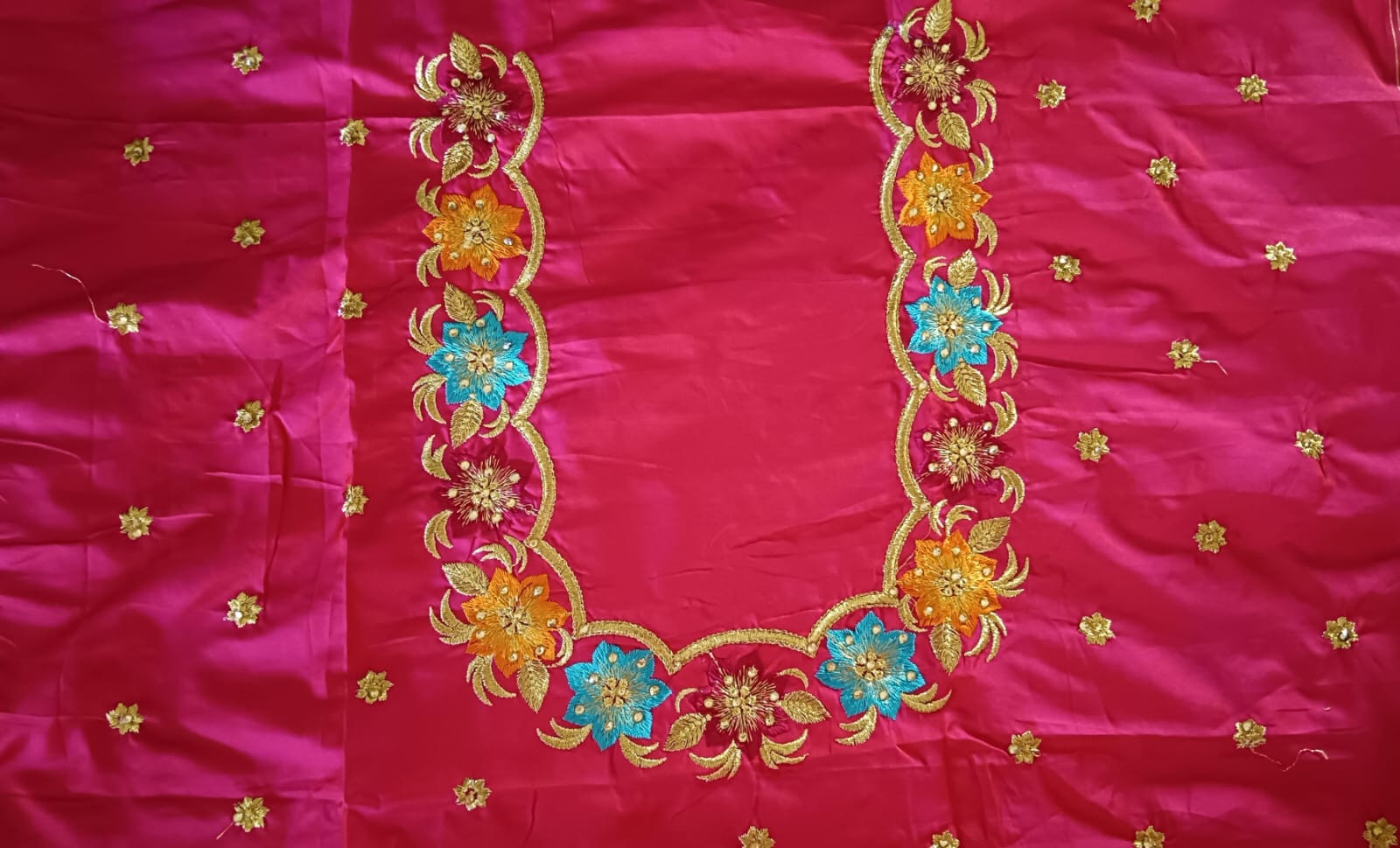 Red and gold embroidered blouse with floral motifs