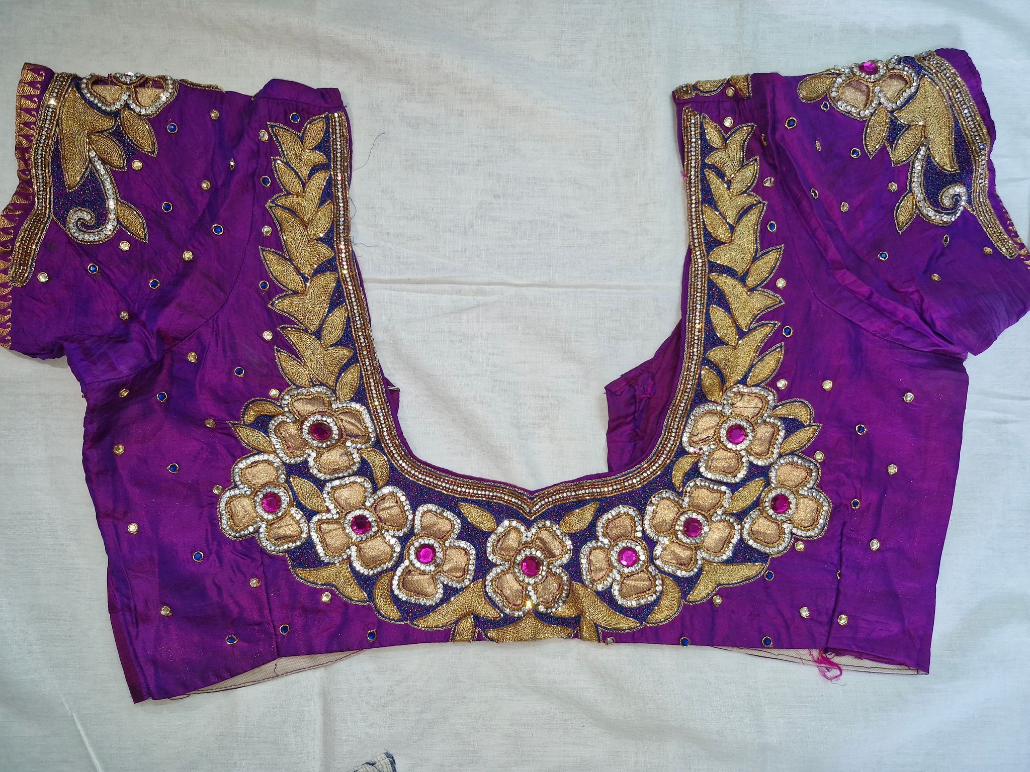 Embroidered boat neck blouse with floral motifs