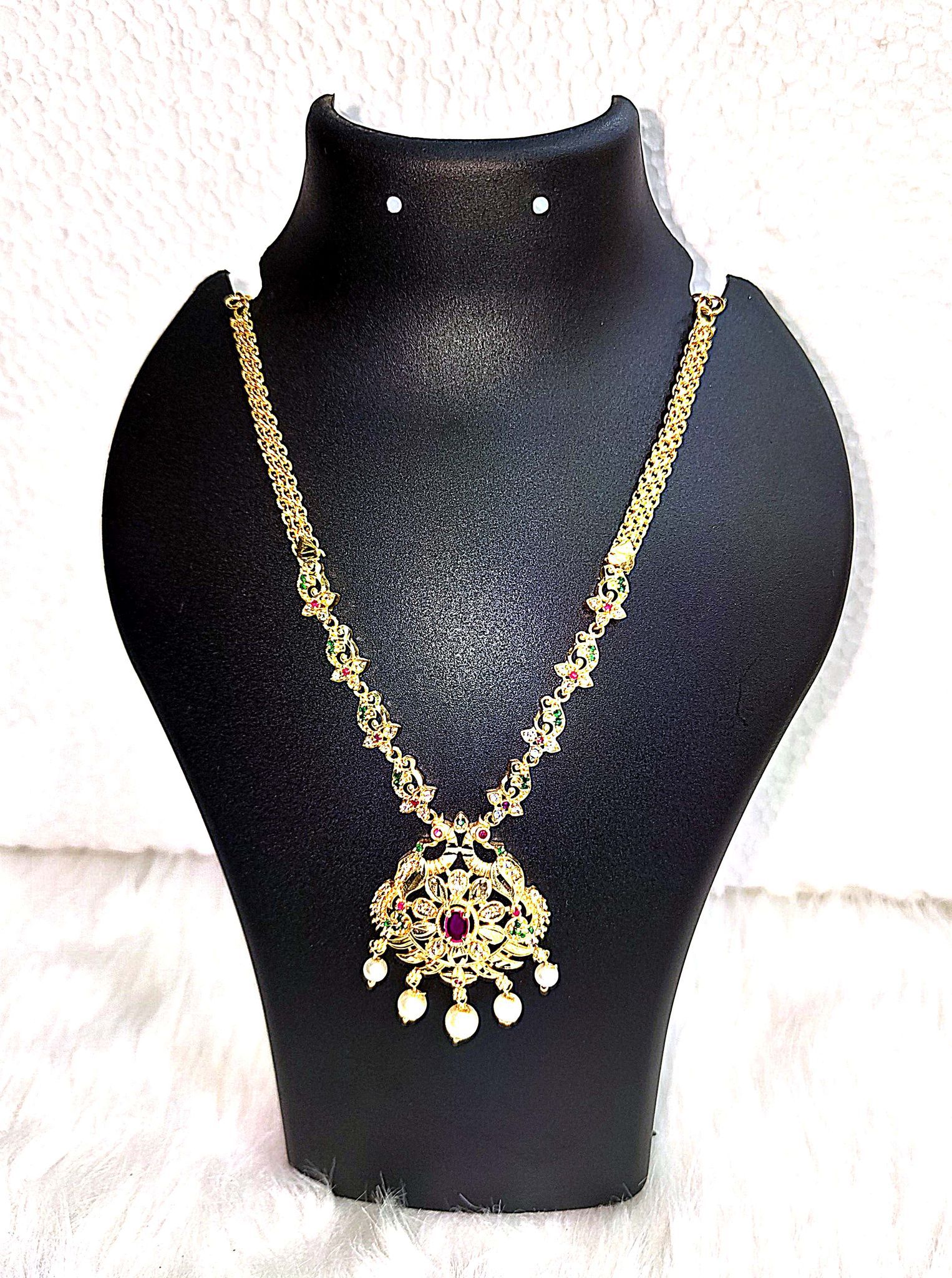 "Stunning Gold-Plated Necklace with Intricate Peacock Pendant and Pearl Drop Detailing"