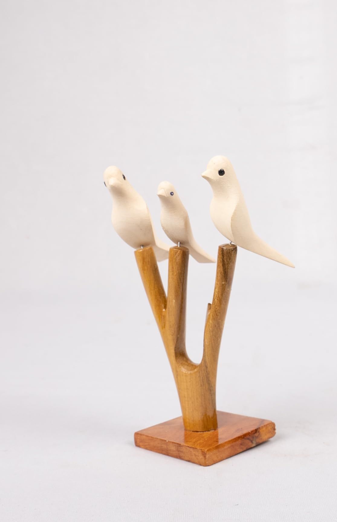 Hand-carved Wooden Bird Figurines on a Branch