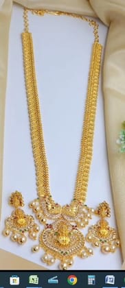 Gold-plated, long necklace with intricate detailing and pearl accents