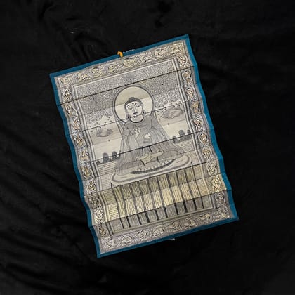 Palm leaf engraving of meditating Buddha