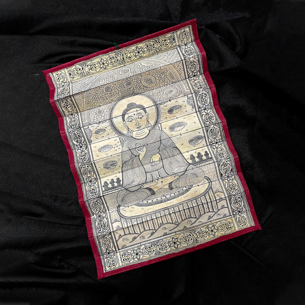 Palm leaf engraving of meditating Buddha