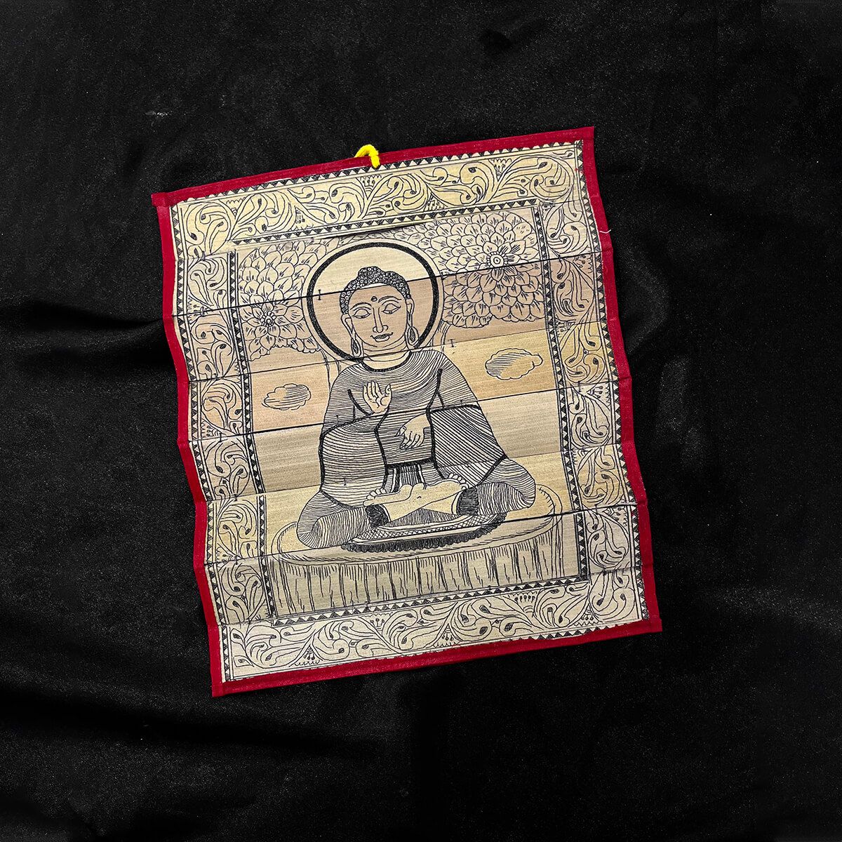 Palm leaf engraving of meditating Buddha