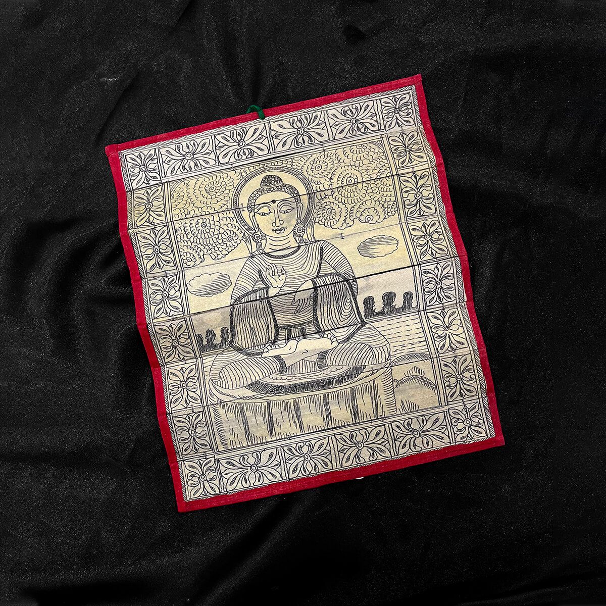 Palm leaf engraving of meditating Buddha