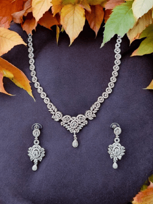 Crafted in 14k white gold, this stunning necklace and earring set features round and pear shaped cubic zirconia stones.