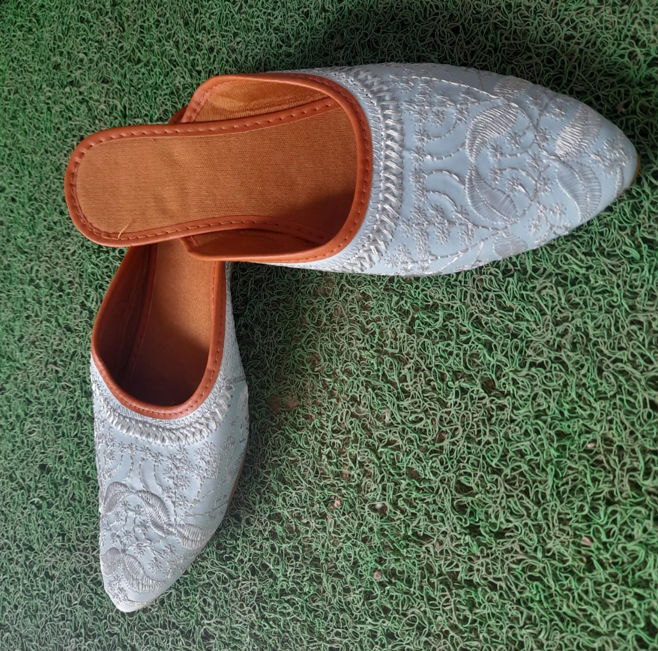 White and silver embroidered slip-on flats with cushioned insole