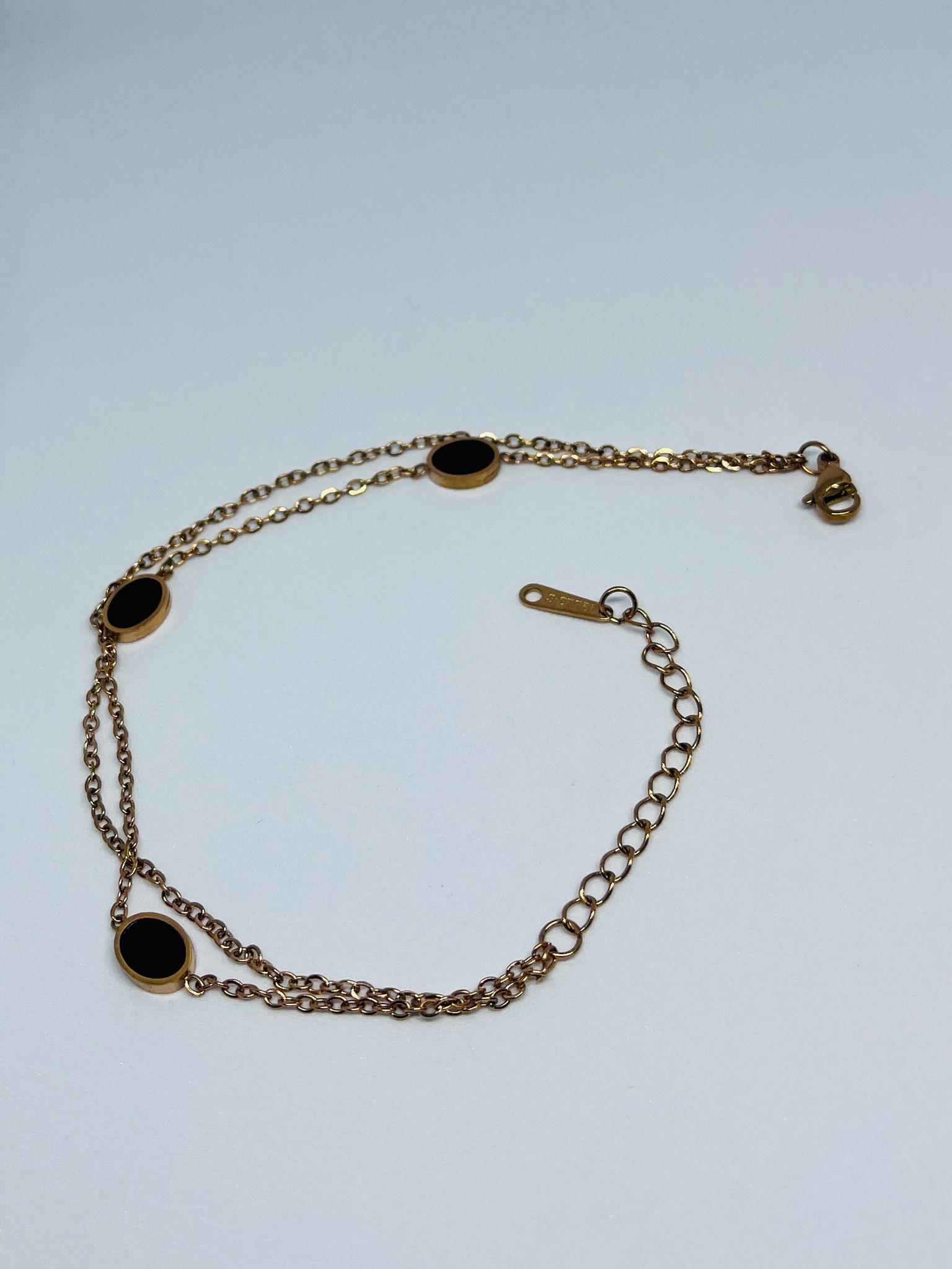 Elegant Gold-Toned Double Chain Bracelet with Black Oval Charms