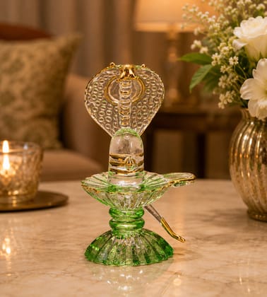 Glass Shivling with Green Stand and Gold Sheshnag - 10 cm Glass Shivling with Green Stand and Gold Sheshnag - 10 cm
