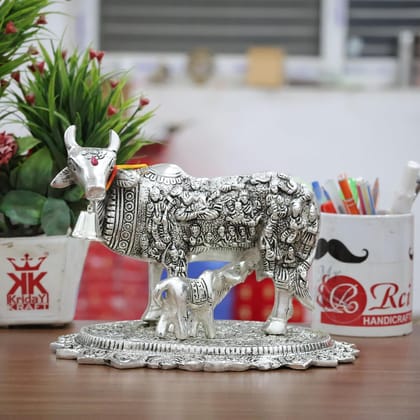 Dreamkraft Decorative Metal Kamdhenu Cow with Calf Statue for Vastu Showpiece (Sliver, 23 X 16 X 16 CM) Dreamkraft Decorative Metal Kamdhenu Cow with Calf Statue for Vastu Showpiece (Sliver, 23 X 16 X 16 CM)