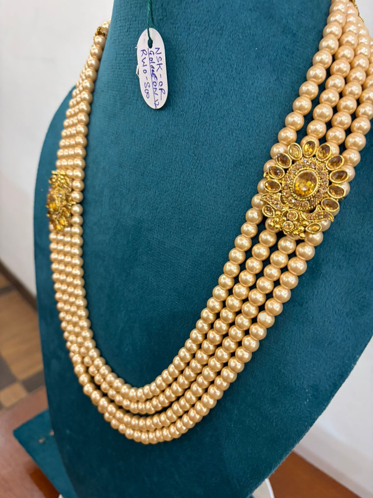 five-layer golden moti pearl necklace with side circular stone brooches