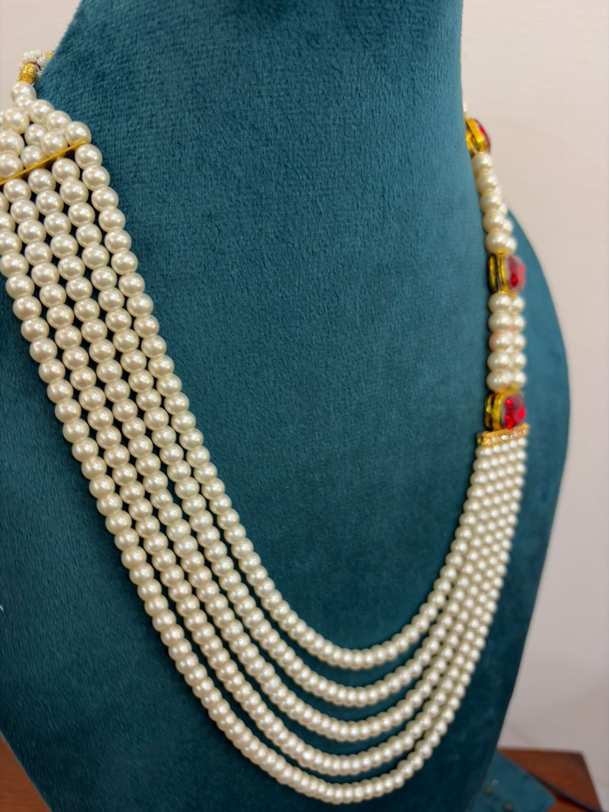 groom and party wear red gold and white pearl mala with side stones